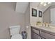 Powder room offers a pedestal sink with framed mirror and a decorative light fixture at 5850 Grey Wood Way, North Las Vegas, NV 89031