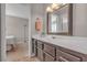 Bathroom featuring single sink vanity and a mirror, with a bedroom visible in the background at 5850 Grey Wood Way, North Las Vegas, NV 89031
