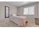 Cozy bedroom features a comfortable single bed, carpet, and natural light at 5850 Grey Wood Way, North Las Vegas, NV 89031