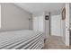 Comfortable bedroom featuring a white-striped bed and ample natural light at 5850 Grey Wood Way, North Las Vegas, NV 89031