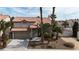 Two-story home with a tile roof, mature palm trees, and a two-car garage at 5850 Grey Wood Way, North Las Vegas, NV 89031