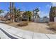Desert-landscaped front yard with palm trees and decorative gravel for low-maintenance appeal at 5850 Grey Wood Way, North Las Vegas, NV 89031