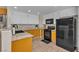 This kitchen features granite countertops, tile flooring, and yellow and white cabinetry at 5850 Grey Wood Way, North Las Vegas, NV 89031