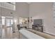 Bright living room with high ceilings, tile floors, and a cozy seating area at 5850 Grey Wood Way, North Las Vegas, NV 89031