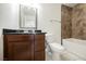 Bathroom featuring a modern vanity with black countertop and a shower with decorative tile surround at 6284 Pinewood Ave, Las Vegas, NV 89103