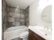 This bathroom features a shower-tub combo and a wooden vanity at 6284 Pinewood Ave, Las Vegas, NV 89103