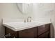 This bathroom vanity features a white countertop, modern faucet, and wood cabinet at 6284 Pinewood Ave, Las Vegas, NV 89103