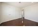 Bedroom featuring hardwood floors, a double-door closet, and an ensuite bathroom at 6284 Pinewood Ave, Las Vegas, NV 89103