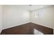 This bedroom has wood floors, a window, and neutral paint at 6284 Pinewood Ave, Las Vegas, NV 89103