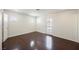 Bright bedroom boasts wood floors, multiple windows, and access to the backyard at 6284 Pinewood Ave, Las Vegas, NV 89103