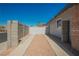 Long driveway with gravel and concrete borders, leading to the side of the home at 6284 Pinewood Ave, Las Vegas, NV 89103