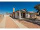 Quaint single-story home featuring a brick chimney, covered porch, and desert-friendly landscaping at 6284 Pinewood Ave, Las Vegas, NV 89103