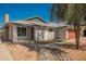 Charming single-story home with desert landscaping, walkway, and a classic brick chimney at 6284 Pinewood Ave, Las Vegas, NV 89103