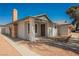 Quaint single-story home featuring a brick chimney, covered porch, and desert-friendly landscaping at 6284 Pinewood Ave, Las Vegas, NV 89103
