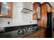 Featuring a gas stove top and black granite countertops with stylish exhaust fan at 6284 Pinewood Ave, Las Vegas, NV 89103