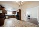 Open kitchen space with stainless steel appliances, tile floor, and granite countertops at 6284 Pinewood Ave, Las Vegas, NV 89103