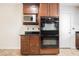 Kitchen built-in appliances: microwave and double oven with wooden cabinets at 6284 Pinewood Ave, Las Vegas, NV 89103
