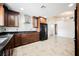 A modern kitchen with stainless steel appliances, dark countertops, and tile flooring at 6284 Pinewood Ave, Las Vegas, NV 89103