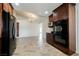 Updated kitchen offering stainless steel appliances, brown cabinetry and tile floors adjacent to the living area at 6284 Pinewood Ave, Las Vegas, NV 89103