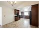 Open kitchen and dining area with brown cabinets, stainless appliances, and tile floors at 6284 Pinewood Ave, Las Vegas, NV 89103