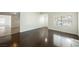 Inviting living room featuring hardwood floors, a large window and adjacent tile-floored dining area at 6284 Pinewood Ave, Las Vegas, NV 89103