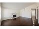 Spacious living room with vaulted ceiling, hardwood floors, white walls, and a marble fireplace at 6284 Pinewood Ave, Las Vegas, NV 89103
