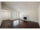Bright living room with vaulted ceiling, dark wood floors, and a modern white marble fireplace at 6284 Pinewood Ave, Las Vegas, NV 89103