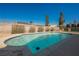 Sparkling blue pool featuring a tile surround and privacy landscaping against a clear blue sky at 6284 Pinewood Ave, Las Vegas, NV 89103