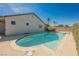 Backyard swimming pool with a concrete patio and a landscaped garden area at 6284 Pinewood Ave, Las Vegas, NV 89103