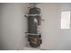 Water heater installed against a wall, featuring modern connections and a compact design at 6284 Pinewood Ave, Las Vegas, NV 89103