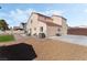 Expansive backyard featuring artificial grass, a patio, and low-maintenance gravel landscaping at 629 Newbridge Way, North Las Vegas, NV 89032