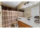 Bathroom showcasing a vanity with sink, tiled floor, and a shower with striped curtain at 629 Newbridge Way, North Las Vegas, NV 89032