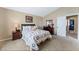 Bright bedroom featuring carpet, neutral paint, a bed and matching wood dressers at 629 Newbridge Way, North Las Vegas, NV 89032