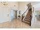 Inviting entryway with tiled floors and a grand staircase welcomes guests with warmth and style at 629 Newbridge Way, North Las Vegas, NV 89032