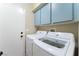 Functional laundry room with modern washer and dryer, overhead cabinets, and a clean, organized space at 629 Newbridge Way, North Las Vegas, NV 89032
