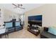 Cozy living room with tile flooring, leather furniture, and a large flatscreen TV at 629 Newbridge Way, North Las Vegas, NV 89032