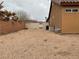 A spacious backyard with gravel, surrounded by fencing for privacy and security at 6420 Emerson St, Pahrump, NV 89048