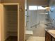 Accessible bathroom with walk-in shower, grab bars, and shelving at 6420 Emerson St, Pahrump, NV 89048