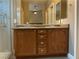 Bathroom featuring double sinks with granite countertops and a large mirror at 6420 Emerson St, Pahrump, NV 89048