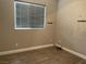 Cozy bedroom features a window and light colored laminate floors at 6420 Emerson St, Pahrump, NV 89048