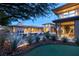 Elegant home featuring a pristine pool, manicured landscaping, and a putting green for outdoor entertainment at 66 Golf Estates Dr, Las Vegas, NV 89141