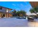 Spacious backyard with a long pool, lounge area, and views from the home's large windows at 66 Golf Estates Dr, Las Vegas, NV 89141
