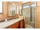 Contemporary bathroom featuring a wood vanity, stone countertop, and glass enclosed shower at 66 Golf Estates Dr, Las Vegas, NV 89141