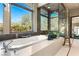 Luxurious bathroom featuring a soaking tub with a view, and a glass-enclosed shower at 66 Golf Estates Dr, Las Vegas, NV 89141