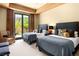 Inviting guest bedroom with two beds, a sitting area, and natural light from a large window at 66 Golf Estates Dr, Las Vegas, NV 89141