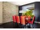Modern dining room with stone accent wall, designer lighting, and seating for eight at 66 Golf Estates Dr, Las Vegas, NV 89141