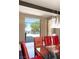 Bright dining area with glass table and red chairs offers scenic outdoor views at 66 Golf Estates Dr, Las Vegas, NV 89141