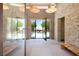 A modern entryway with stone walls and a view of the backyard pool and lush landscape at 66 Golf Estates Dr, Las Vegas, NV 89141