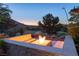 Inviting outdoor area featuring a modern fire pit with built-in seating and scenic views at 66 Golf Estates Dr, Las Vegas, NV 89141