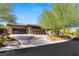 Modern desert home with drought-resistant landscaping and an inviting circular driveway at 66 Golf Estates Dr, Las Vegas, NV 89141